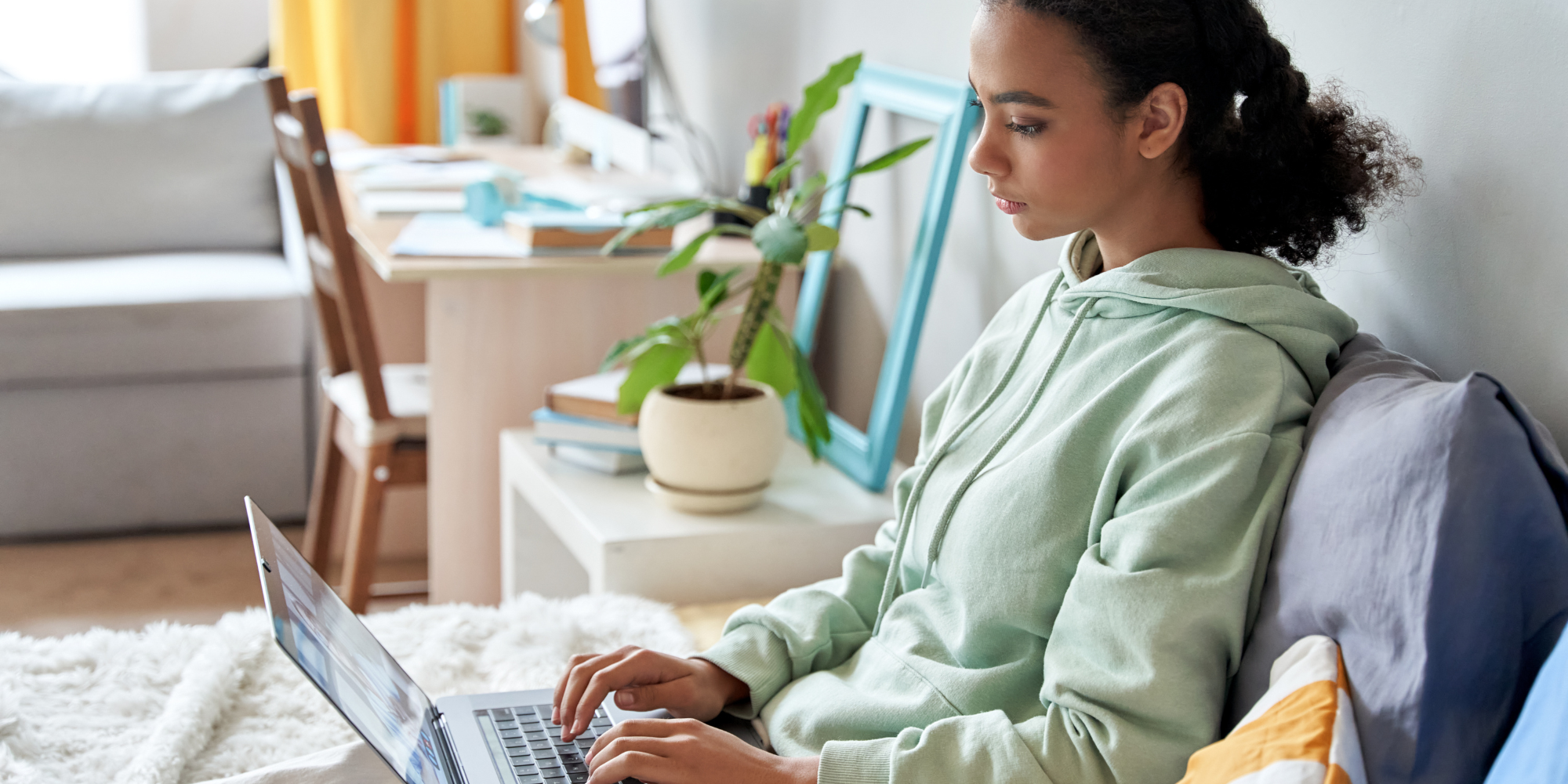 teenage girl looking at laptop